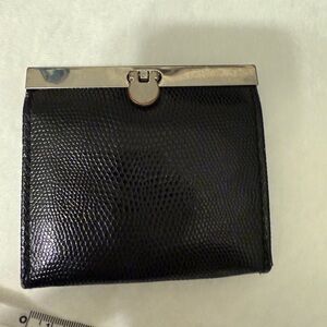 Unbranded (pu) leather- black. Flip turn lock coin/credit card wallet